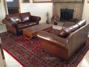 two leather sofas and a chair